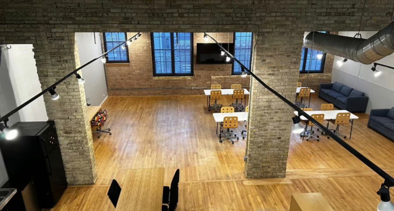 Loft-style studio space with tables for workshops
