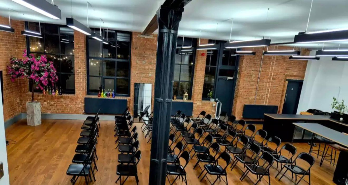 Conference seating arranged inside an exposed brick venue