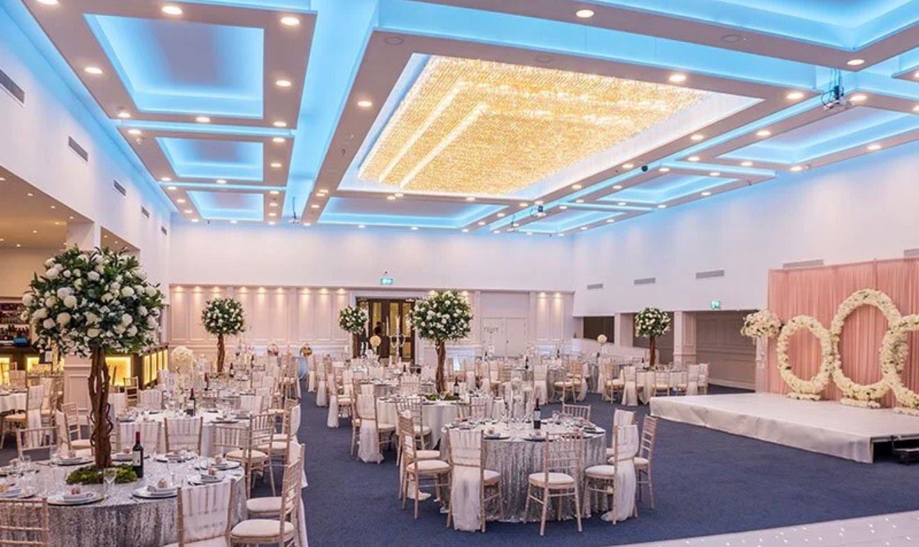 Grand ballroom with stage and floral decor