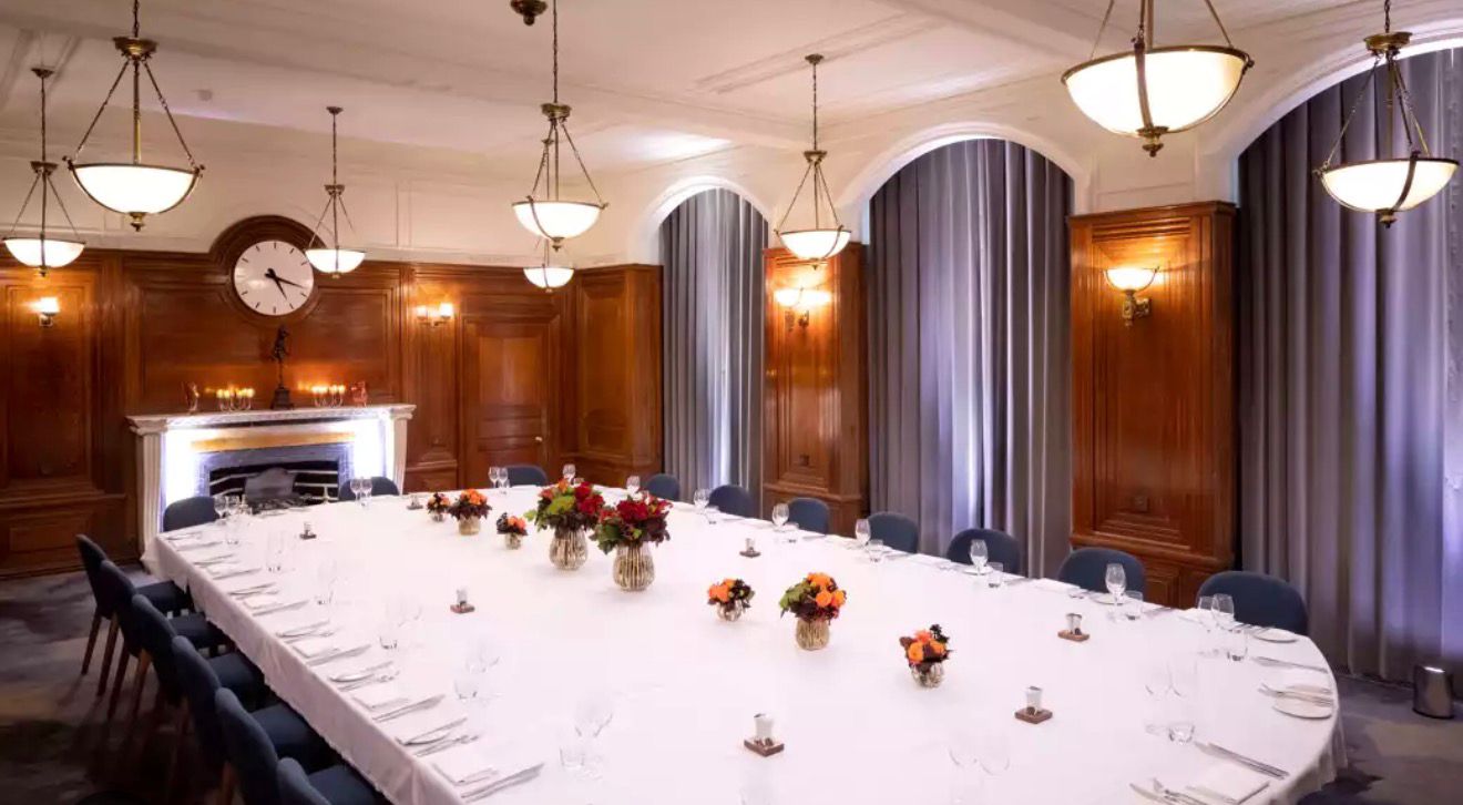 Wood-panel dining room with a long meeting table