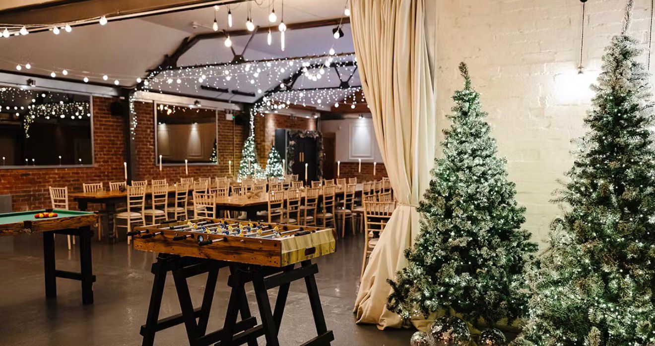 Social venue with games, dining tables, and warm lighting
