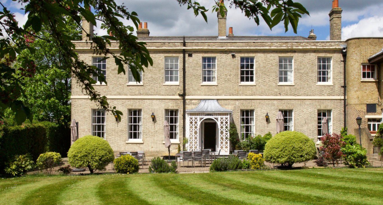 Country house venue exterior with landscaped gardens